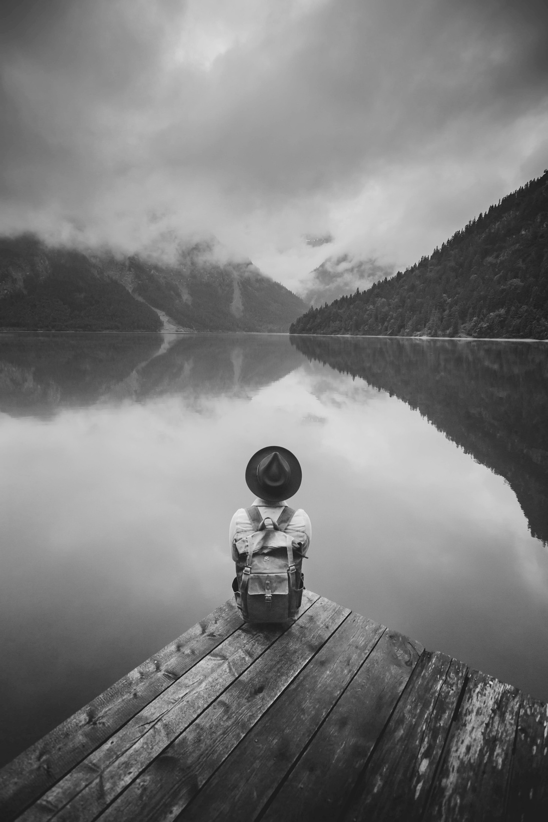 Child Sitting on Wooden Dock Overlooking the Lake